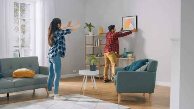Couple Hanging Picture on the Wall